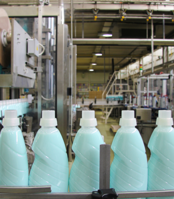 Bottles of detergent going through a conveyor line in a production facility