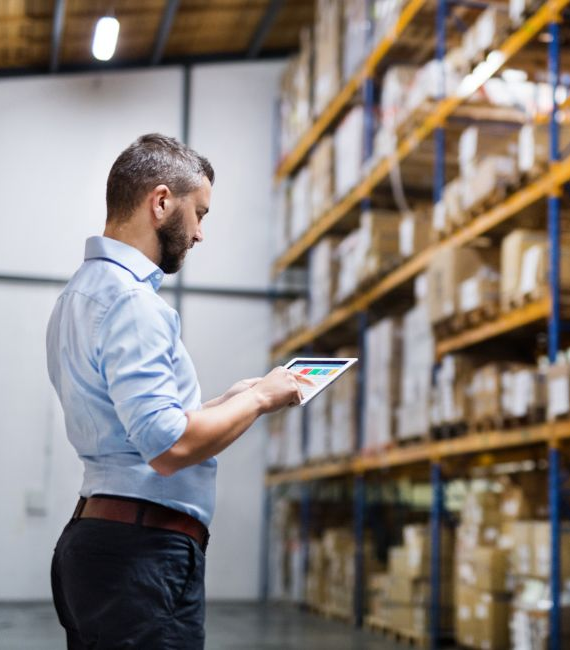 Image 6 - Manager reviewing manufacturing information on a tablet in a warehouse_