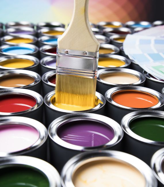 Paint brush dipping into yellow can environment health safety
