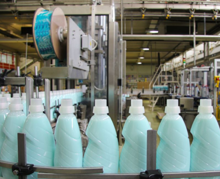 Hundreds of dish soap bottles on a conveyor belt in a factory