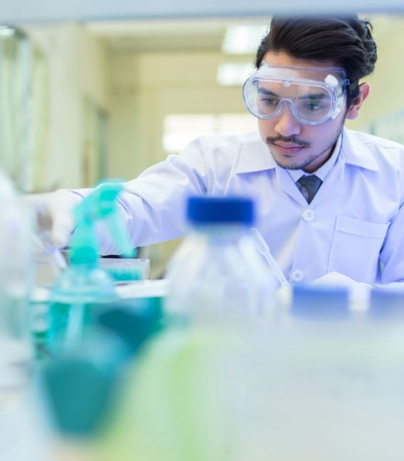 Selerant quality management man in lab coat working with chemicals