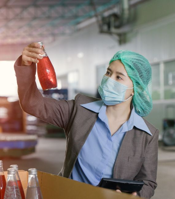Selerant food and beverage product development and compliance woman looks at product in factory